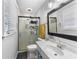 Well-lit bathroom featuring glass enclosed shower and modern vanity at 3261 Hidden Forest Dr, Snellville, GA 30078