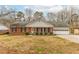 Charming brick home featuring an attached garage and a well-manicured front yard at 3261 Hidden Forest Dr, Snellville, GA 30078