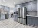 Updated kitchen featuring stainless steel appliances, granite countertops, and stylish gray cabinetry at 3261 Hidden Forest Dr, Snellville, GA 30078