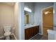 Bathroom featuring a toilet, and a double sink vanity with modern lighting at 5592 Bluegrass Dr, Atlanta, GA 30349