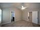 Spacious bedroom featuring neutral walls, carpet flooring, and a ceiling fan for added comfort at 5592 Bluegrass Dr, Atlanta, GA 30349