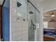 Bathroom featuring tiled shower with glass door and view of bedroom at 20 Alison Trail, Covington, GA 30014
