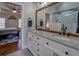 Bathroom featuring double vanity with granite countertop and large, tiled shower with glass enclosure at 20 Alison Trail, Covington, GA 30014