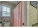 Bathroom with shower featuring a pink shower curtain and window at 20 Alison Trail, Covington, GA 30014