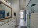 Bathroom featuring tiled walk-in shower with glass door and double vanity with granite countertop at 20 Alison Trail, Covington, GA 30014