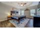 Spacious bedroom with a tray ceiling, a ceiling fan, and natural light from two windows at 20 Alison Trail, Covington, GA 30014
