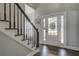 Welcoming entryway with hardwood floors, staircase with black railing, and sidelight windows at 20 Alison Trail, Covington, GA 30014