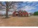 Charming two-story red brick home with a well-maintained yard and mature trees at 20 Alison Trail, Covington, GA 30014