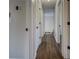 Hallway featuring hardwood floors and white doors at 20 Alison Trail, Covington, GA 30014