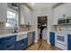 View of the kitchen featuring stainless appliances, tiled backsplash, and an adjacent laundry room at 20 Alison Trail, Covington, GA 30014