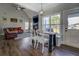 Open-concept living room featuring hardwood floors, a vaulted ceiling, and a cozy seating area with a fireplace at 20 Alison Trail, Covington, GA 30014