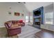Bright living room features a cozy fireplace, hardwood floors, and comfortable seating at 20 Alison Trail, Covington, GA 30014
