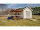 White shed with covered area for equipment storage at 20 Alison Trail, Covington, GA 30014