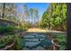 Lush backyard with stone pathway, manicured landscaping, and mature trees, creating a private retreat at 3150 Shumard Way, Marietta, GA 30064