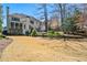 Expansive backyard featuring a lush lawn, mature trees, and a charming patio area, perfect for outdoor entertaining at 3150 Shumard Way, Marietta, GA 30064
