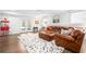 Finished basement space with french doors, and a brown leather sofa at 3150 Shumard Way, Marietta, GA 30064