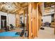 Unfinished basement with exposed wood framing, fitness equipment, and weights at 3150 Shumard Way, Marietta, GA 30064