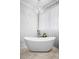 Bright bathroom with a freestanding tub, elegant chandelier, and sheer curtains at 3150 Shumard Way, Marietta, GA 30064