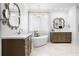 Bright bathroom with dual vanities, soaking tub, and elegant chandelier at 3150 Shumard Way, Marietta, GA 30064