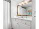 Bright bathroom with a white vanity, framed mirror, and white shower curtain at 3150 Shumard Way, Marietta, GA 30064