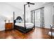 Spacious bedroom with a four-poster bed, hardwood floors, and natural light from a large window at 3150 Shumard Way, Marietta, GA 30064