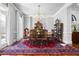 Elegant dining room featuring a vintage rug, chandelier, and decorative wood table and chairs at 3150 Shumard Way, Marietta, GA 30064
