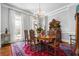 Formal dining area showcases a chandelier and rustic table set with hardwood flooring and natural light at 3150 Shumard Way, Marietta, GA 30064