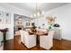 Dining room featuring wainscoting, and an open layout connecting to living room with coffered ceilings at 3150 Shumard Way, Marietta, GA 30064