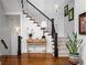 Elegant foyer with hardwood floors, a staircase with a black wrought iron railing and stylish decor at 3150 Shumard Way, Marietta, GA 30064
