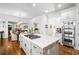 Bright, open kitchen with a center island, stainless steel appliances, and hardwood floors at 3150 Shumard Way, Marietta, GA 30064