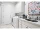 Bright laundry room with modern appliances, custom cabinetry, and a convenient utility sink at 3150 Shumard Way, Marietta, GA 30064