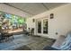 Charming covered patio with stone flooring, outdoor seating, and access to the home's interior at 3150 Shumard Way, Marietta, GA 30064