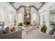 Cozy sunroom featuring a stone fireplace, vaulted ceiling, and lots of natural light at 3150 Shumard Way, Marietta, GA 30064
