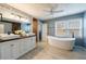 Stylish bathroom with double sink vanity, soaking tub, and natural light creating a spa-like atmosphere at 3310 Forest Creek Sw Dr, Marietta, GA 30064