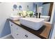 Close up on an elegant bathroom featuring double sinks on a modern vanity with a dark wood countertop at 3310 Forest Creek Sw Dr, Marietta, GA 30064