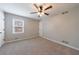 A large bedroom with neutral carpet and a ceiling fan and a double window at 3310 Forest Creek Sw Dr, Marietta, GA 30064