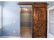 Walk-in closet with a sliding barn door and built-in shelves for optimal storage at 3310 Forest Creek Sw Dr, Marietta, GA 30064