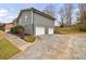 The side view of a home featuring a two-car garage and driveway at 3310 Forest Creek Sw Dr, Marietta, GA 30064