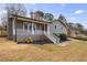 Charming home with a cozy front porch, brick chimney, and landscaping at 3310 Forest Creek Sw Dr, Marietta, GA 30064