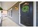 A cozy gray-toned porch featuring a dark front door with a decorative wreath at 3310 Forest Creek Sw Dr, Marietta, GA 30064