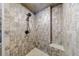 A stone tiled shower with a rainfall shower head and a built-in corner seat at 3310 Forest Creek Sw Dr, Marietta, GA 30064