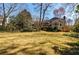 Expansive backyard featuring mature trees and an open grassy area, ideal for recreation at 656 Gunby Se Rd, Marietta, GA 30067