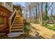 Wooden stairs lead to backyard oasis surrounded by mature trees at 656 Gunby Se Rd, Marietta, GA 30067