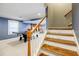 Staircase leading down to the finished basement, with a game area beyond, perfect for recreation at 656 Gunby Se Rd, Marietta, GA 30067