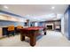Finished basement featuring a pool table, bar, brick fireplace, and abundant space for Gathering enjoyment at 656 Gunby Se Rd, Marietta, GA 30067