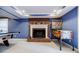 Finished basement with a brick fireplace, mantle with decor, and pinball machine at 656 Gunby Se Rd, Marietta, GA 30067