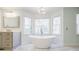 Bright bathroom featuring a modern standalone tub and a large window at 656 Gunby Se Rd, Marietta, GA 30067