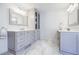 Elegant bathroom showcasing custom cabinetry, granite counters, double vanity, and marble floors at 656 Gunby Se Rd, Marietta, GA 30067