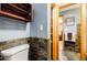 Charming bathroom featuring slate accent wall and open doorway to the main bedroom at 656 Gunby Se Rd, Marietta, GA 30067