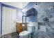 Modern bathroom featuring stone tiled shower, wood vanity, and striking pebble tile floor at 656 Gunby Se Rd, Marietta, GA 30067